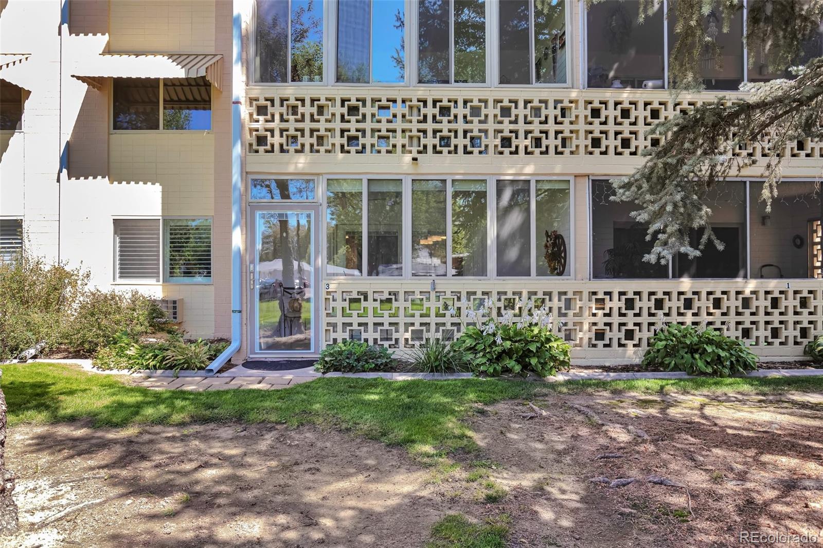 650 South Clinton Street, Unit 3A Denver, CO 80247 - Photo 2 of 25 front view of a brick house with a small yard