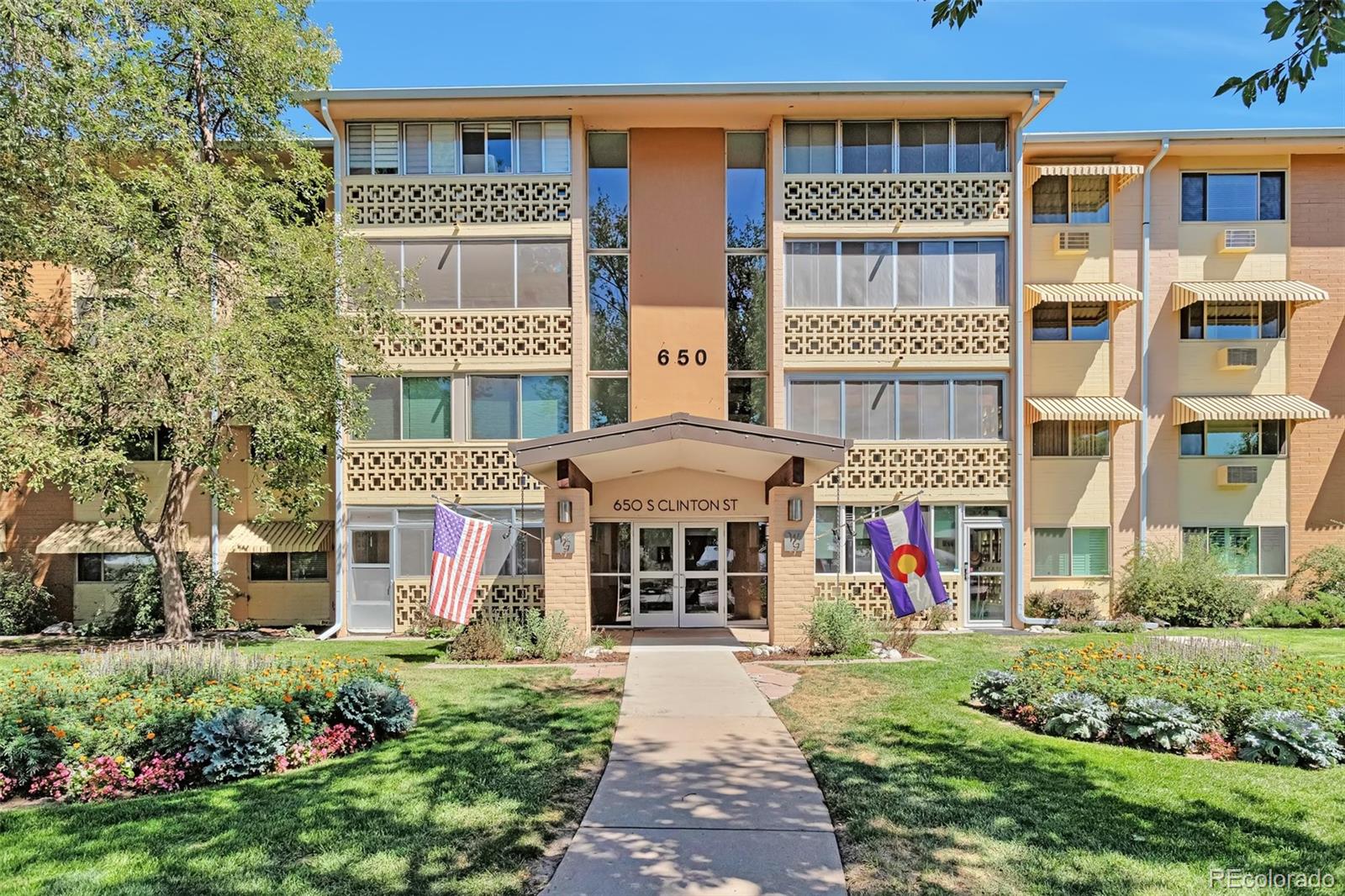 650 South Clinton Street, Unit 3A Denver, CO 80247 - Photo 25 of 25 front view of a brick building with a yard