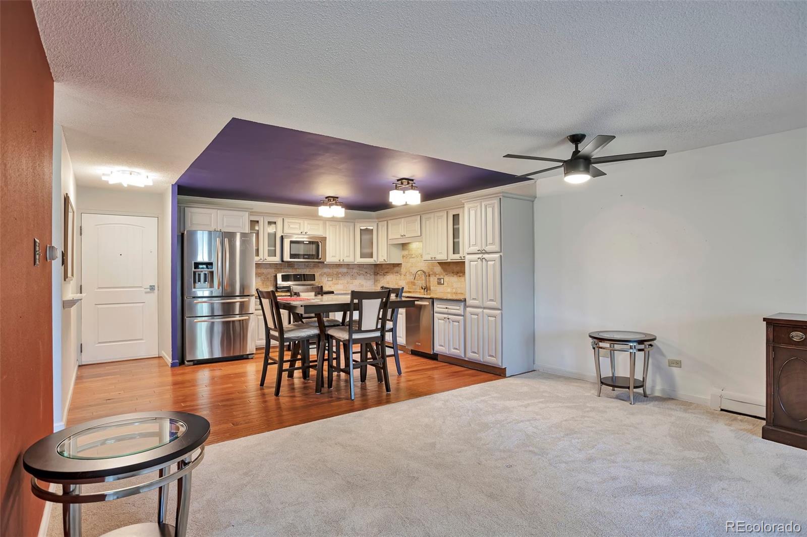 650 South Clinton Street, Unit 3A Denver, CO 80247 - Photo 7 of 25 a view of a dining room with furniture and wooden floor