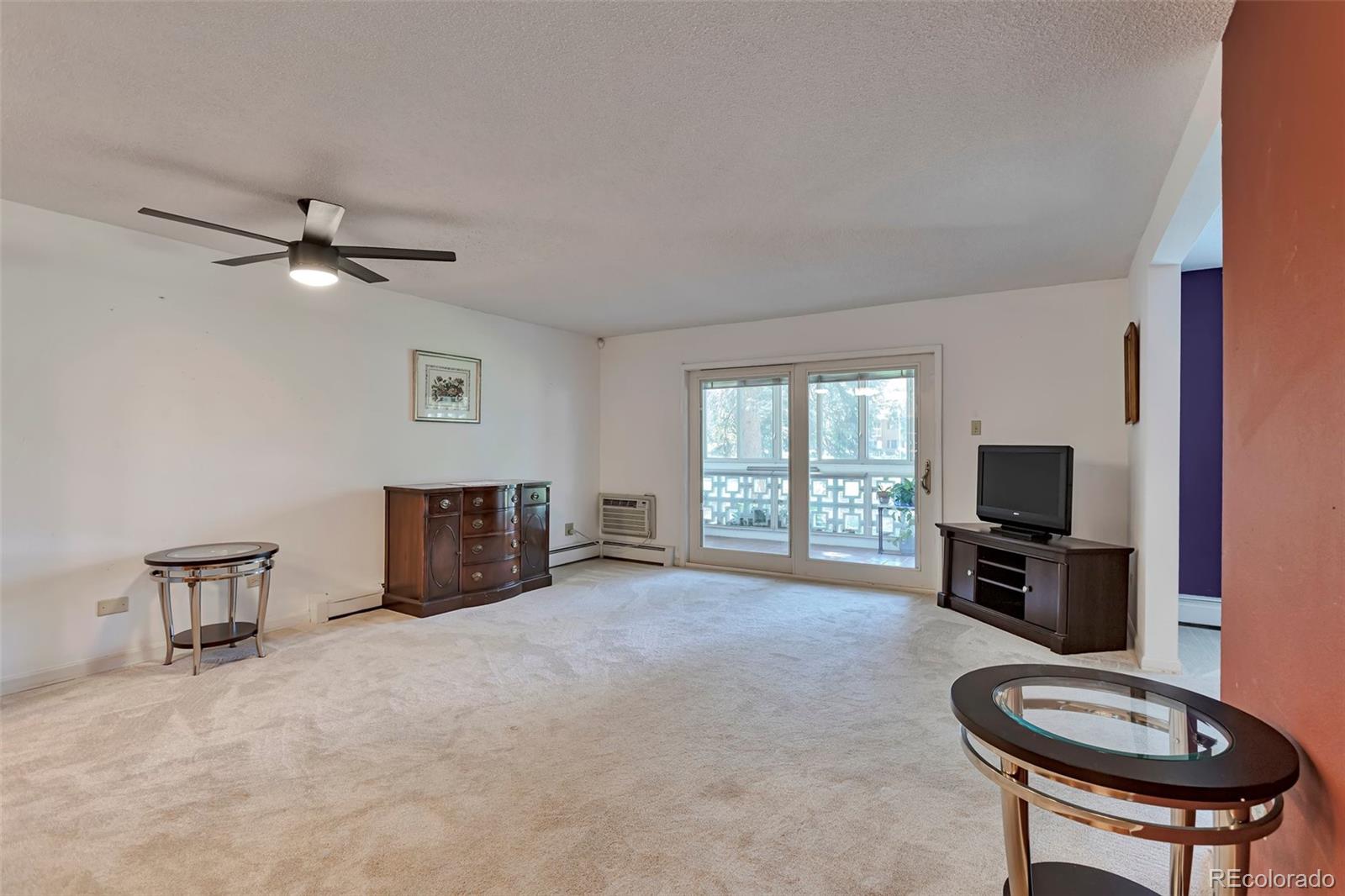 650 South Clinton Street, Unit 3A Denver, CO 80247 - Photo 8 of 25 a living room with furniture a fireplace and a flat screen tv