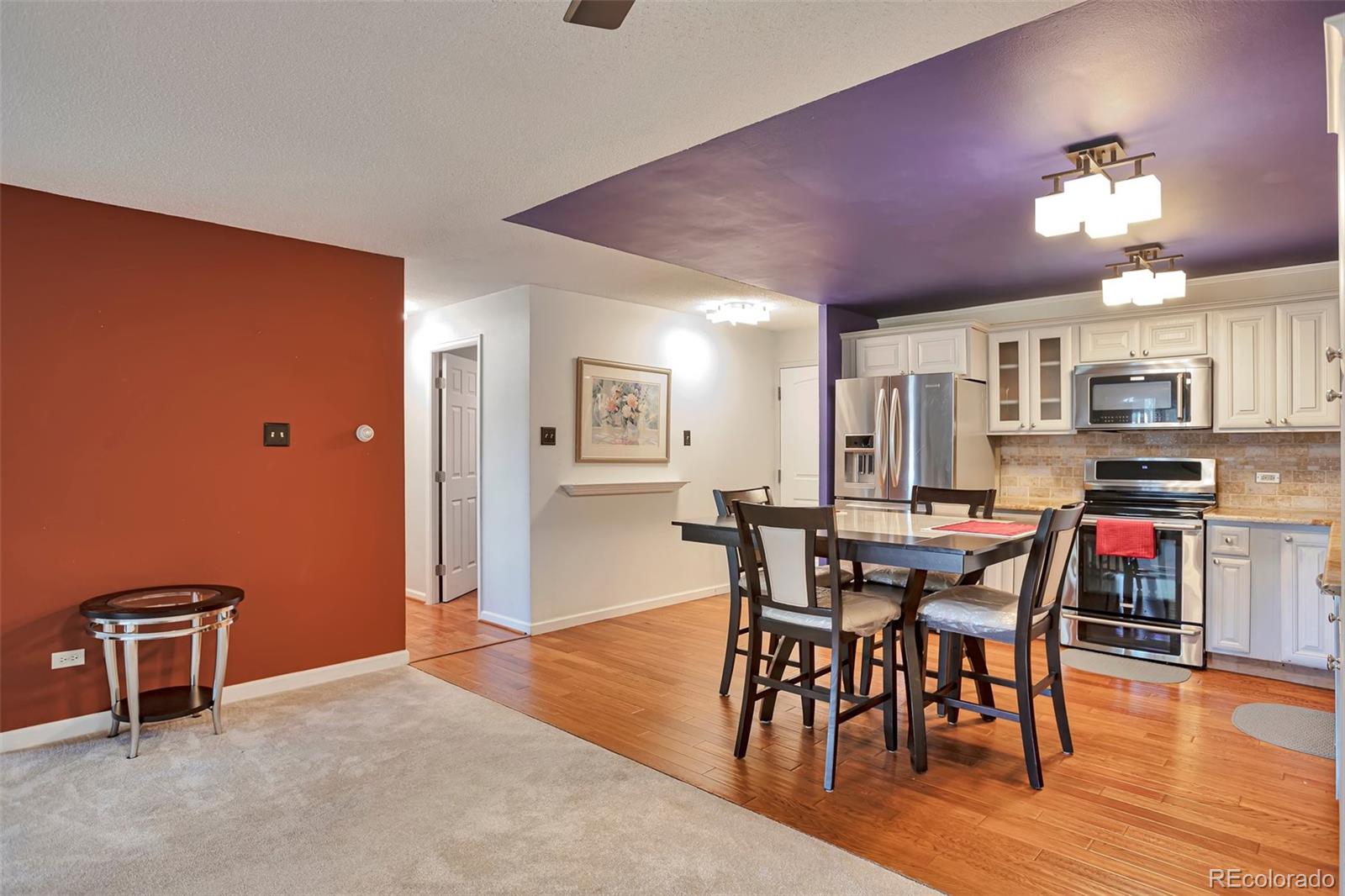 650 South Clinton Street, Unit 3A Denver, CO 80247 - Photo 9 of 25 a view of a dining room with furniture and wooden floor