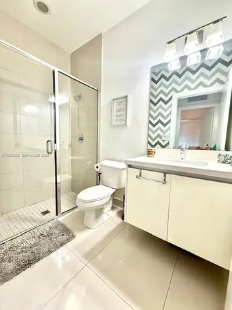 a spacious bathroom with a sink mirror and a shower