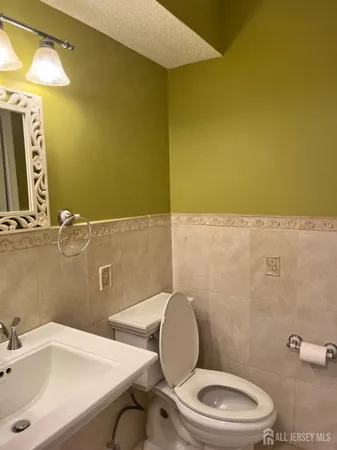 a bathroom with a sink mirror vanity and toilet