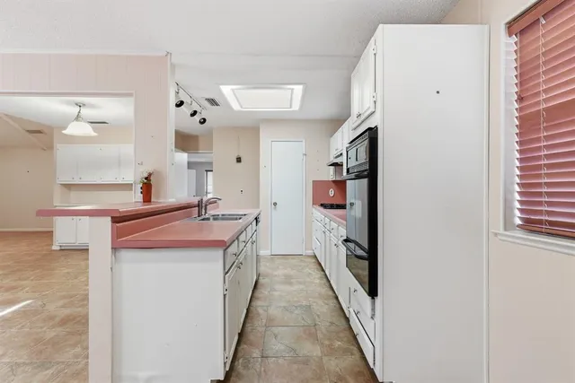 a kitchen with stainless steel appliances granite countertop a stove and a refrigerator