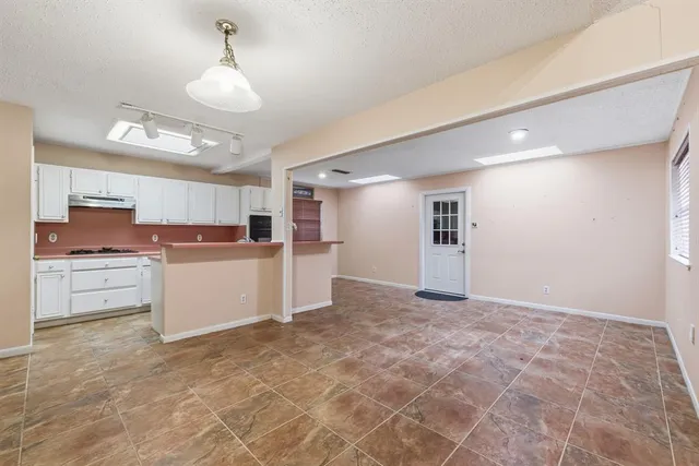 a view of a kitchen with a sink and cabinets