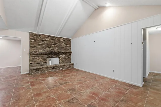 a view of an empty room with a fireplace