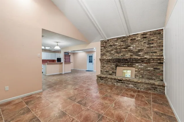 a view of empty room with a fireplace