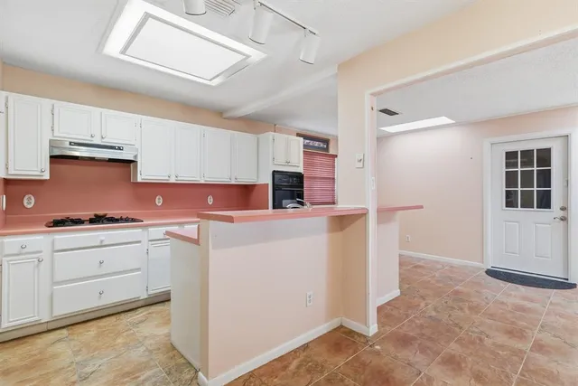 a kitchen with granite countertop cabinets and white appliances