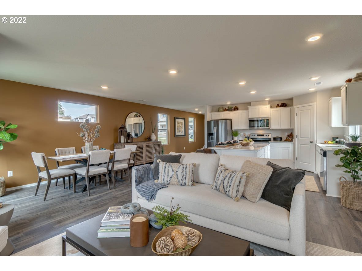 917 Northwest 174th Street Ridgefield, WA 98642 - Photo 6 of 19 a living room with furniture kitchen view and a dining table