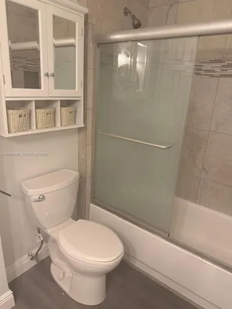 a bathroom with a toilet and a shower