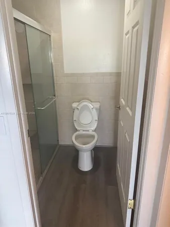 a white toilet sitting in a bathroom