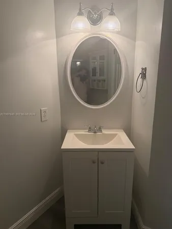 a bathroom with a sink and mirror