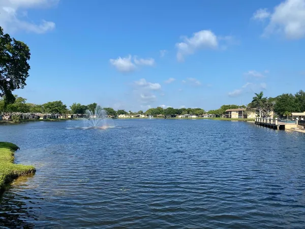 a view of a lake with houses in back
