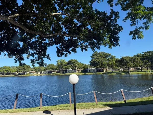 a view of a lake with houses in the back