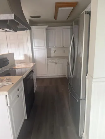 a kitchen with a refrigerator and a sink