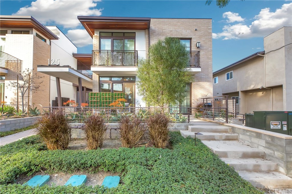 125 Hurlbut Street, Unit 101 Pasadena, CA 91105 - Photo 1 of 53 a view of a brick house with a yard and plants