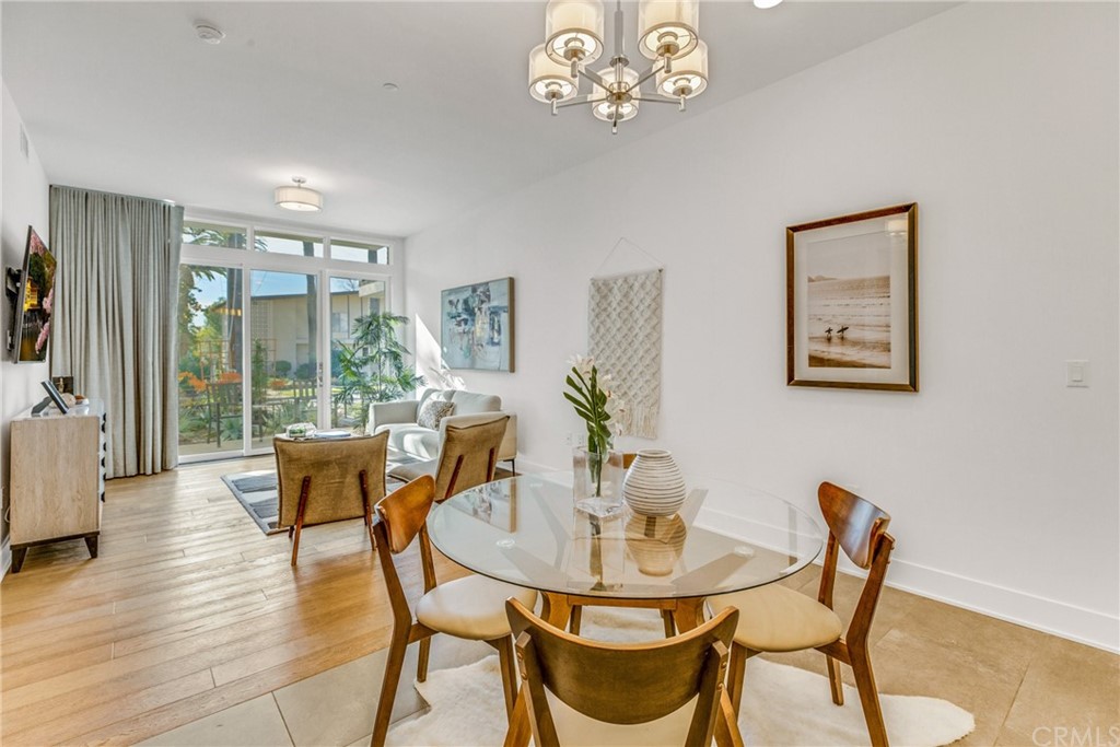 125 Hurlbut Street, Unit 101 Pasadena, CA 91105 - Photo 11 of 53 a view of a dining room with furniture window and wooden floor