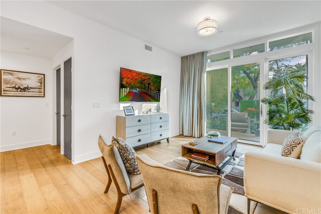 125 Hurlbut Street, Unit 101 Pasadena, CA 91105 - Photo 13 of 53 a living room with furniture and a flat screen tv