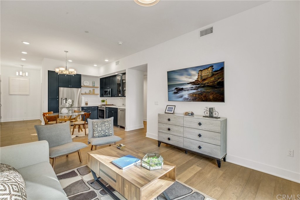 125 Hurlbut Street, Unit 101 Pasadena, CA 91105 - Photo 14 of 53 a living room with furniture and a flat screen tv