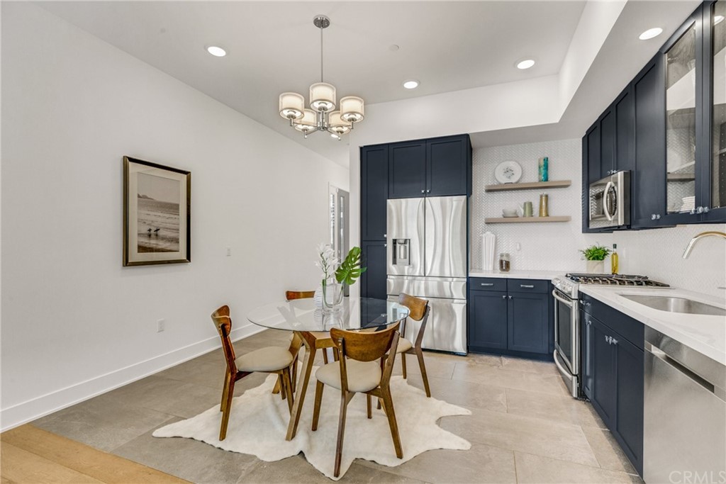 125 Hurlbut Street, Unit 101 Pasadena, CA 91105 - Photo 18 of 53 a view of a dining room with furniture a rug and wooden floor