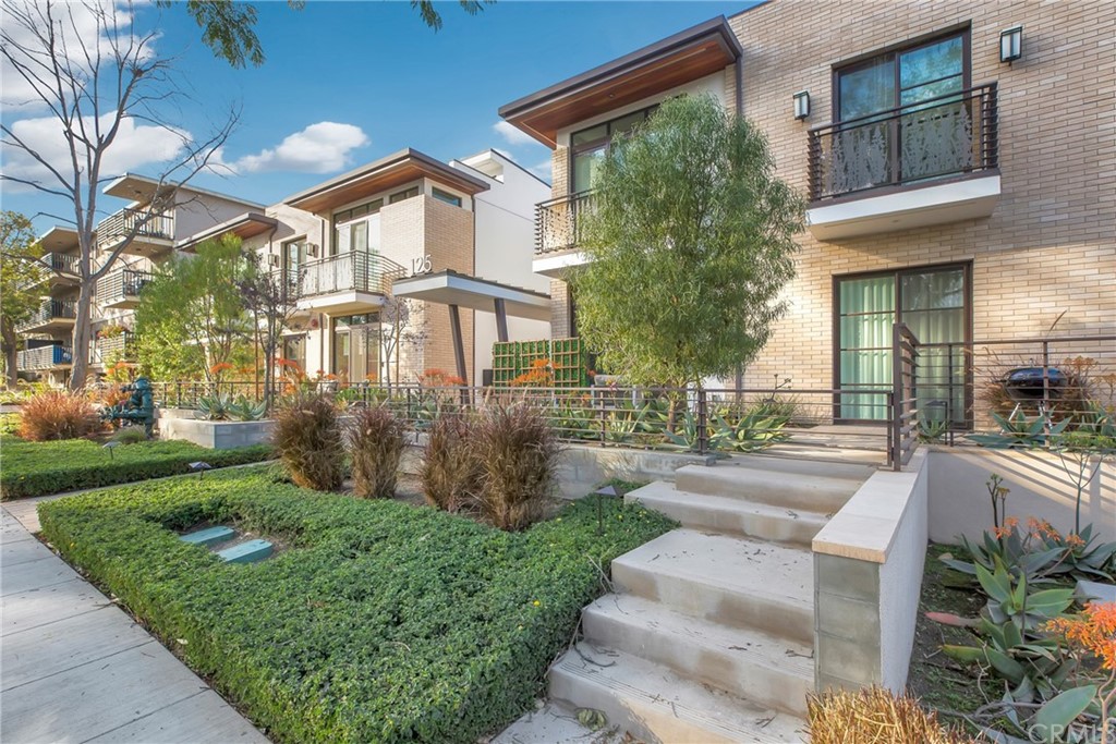 125 Hurlbut Street, Unit 101 Pasadena, CA 91105 - Photo 2 of 53 a view of a house with brick walls and a yard with plants