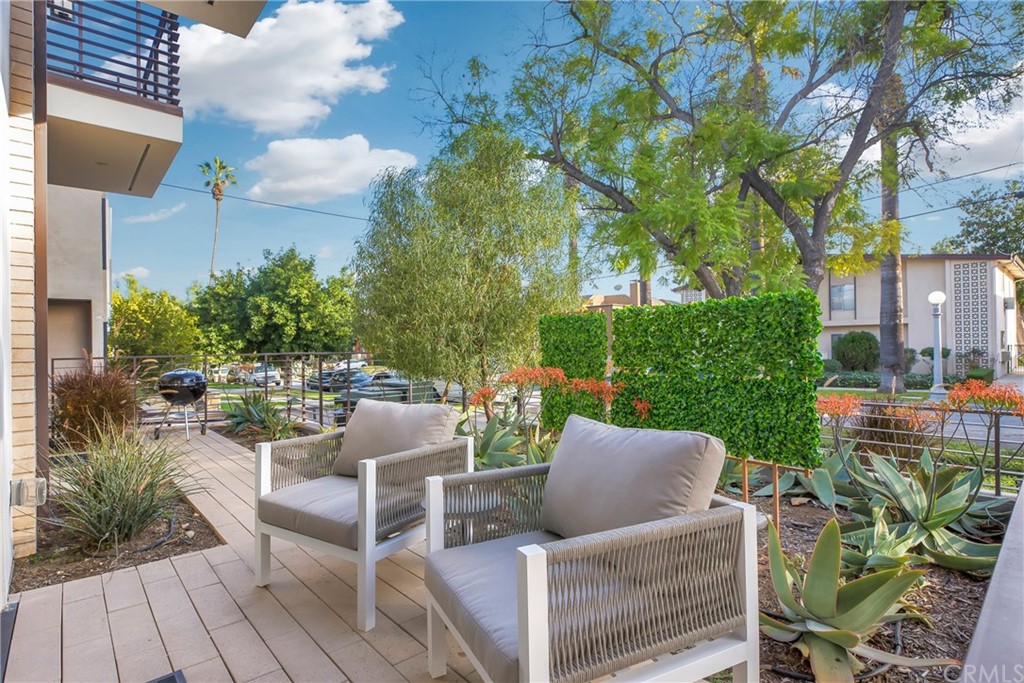 125 Hurlbut Street, Unit 101 Pasadena, CA 91105 - Photo 33 of 53 a view of a patio with couches table and chairs and potted plants
