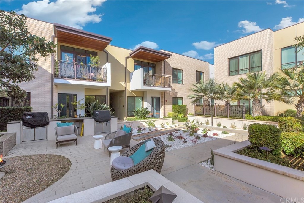 125 Hurlbut Street, Unit 101 Pasadena, CA 91105 - Photo 39 of 53 a view of a patio with couches table and chairs and potted plants