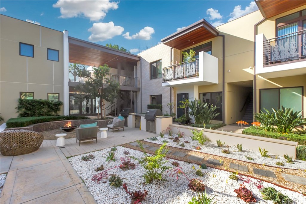 125 Hurlbut Street, Unit 101 Pasadena, CA 91105 - Photo 40 of 53 a view of a patio with couches table and chairs and potted plants