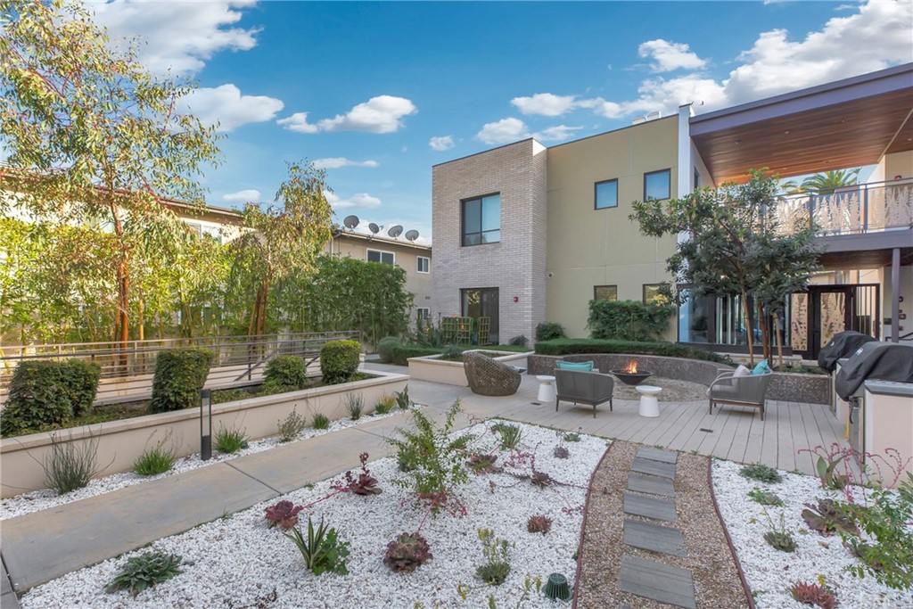 125 Hurlbut Street, Unit 101 Pasadena, CA 91105 - Photo 53 of 53 a view of a patio with couches and table and chairs and potted plants