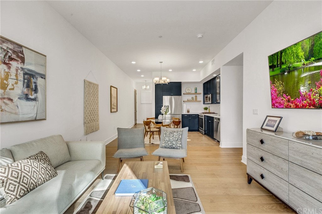 125 Hurlbut Street, Unit 101 Pasadena, CA 91105 - Photo 9 of 53 a living room with furniture and a flat screen tv