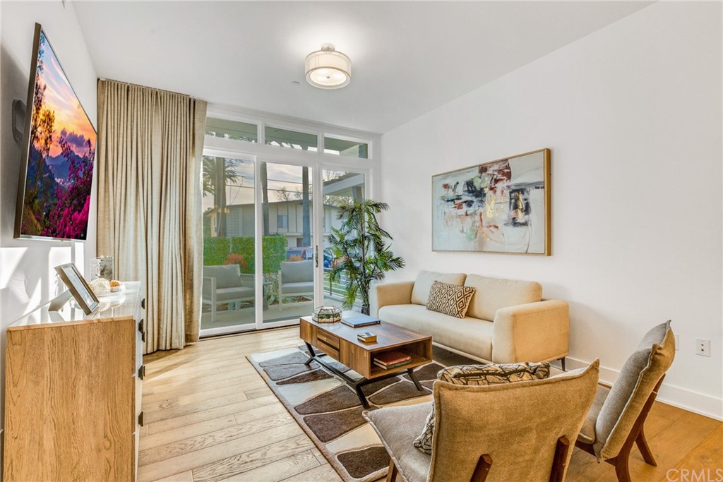 125 Hurlbut Street, Unit 101 Pasadena, CA 91105 - Photo 10 of 53 a living room with furniture a flat screen tv and a large window