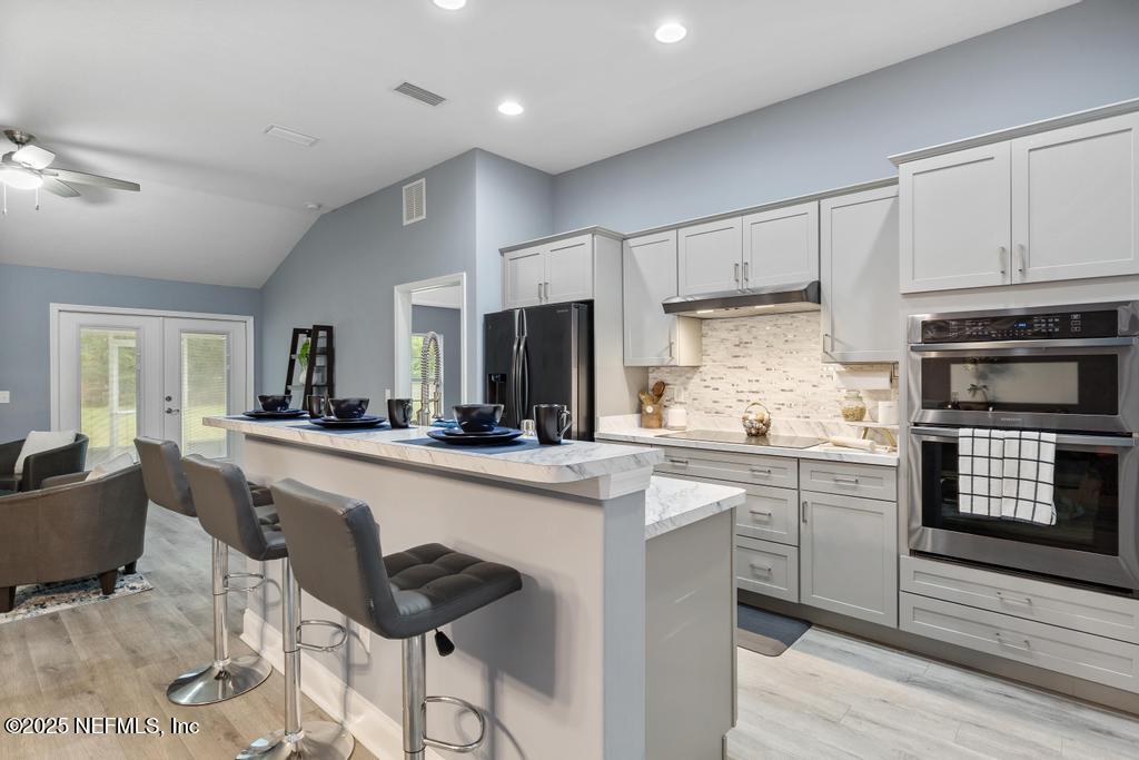 54174 Deerfield Country Club Road Callahan, FL 32011 - Photo 1 of 36 a kitchen with appliances cabinets and furniture
