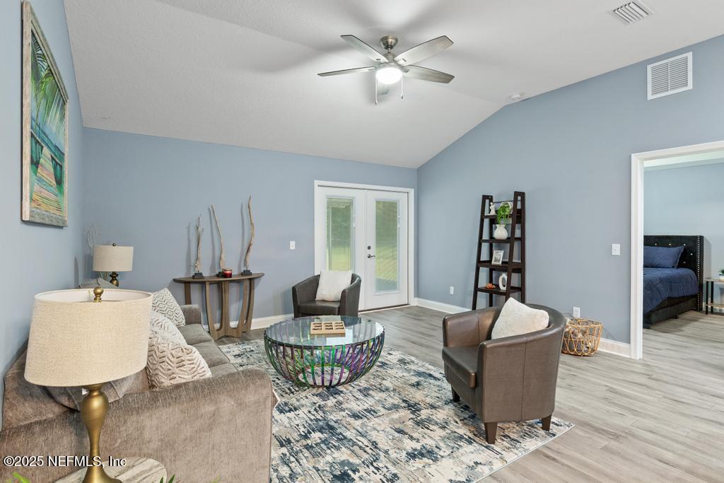 54174 Deerfield Country Club Road Callahan, FL 32011 - Photo 16 of 36 a living room with furniture and a wooden floor