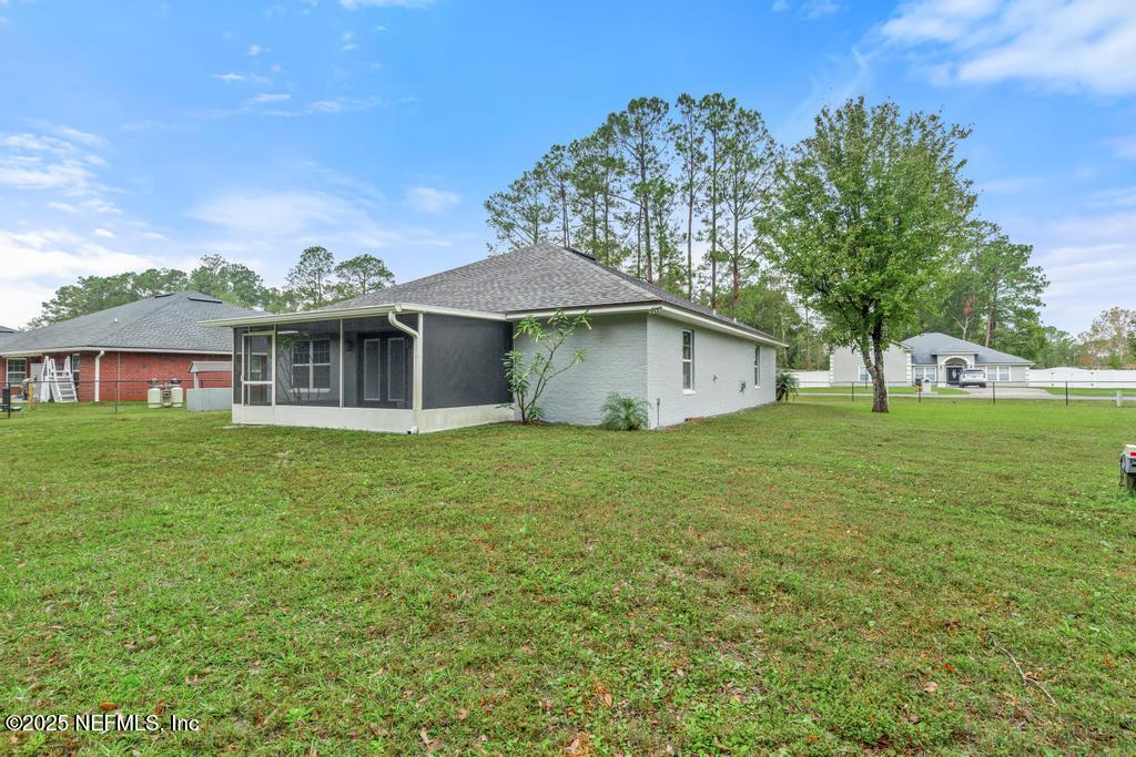 54174 Deerfield Country Club Road Callahan, FL 32011 - Photo 35 of 36 a view of a house with a backyard