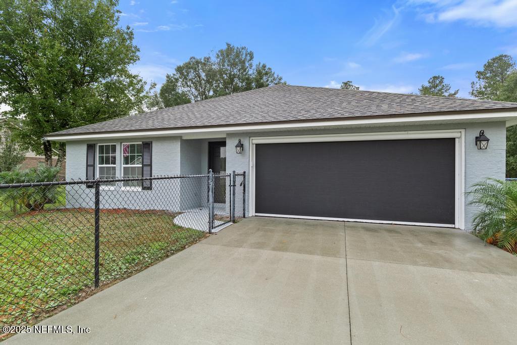 54174 Deerfield Country Club Road Callahan, FL 32011 - Photo 36 of 36 a front view of a house with a yard and garage