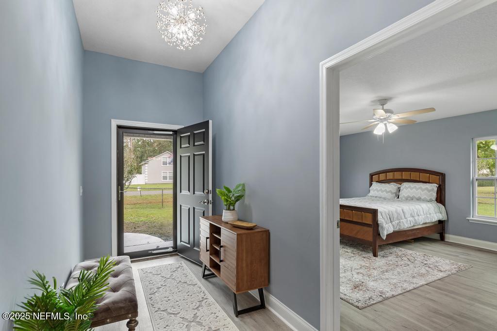 54174 Deerfield Country Club Road Callahan, FL 32011 - Photo 6 of 36 a bedroom with a bed and a chandelier