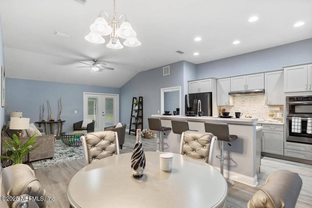 54174 Deerfield Country Club Road Callahan, FL 32011 - Photo 10 of 36 a living room with kitchen island furniture and kitchen view