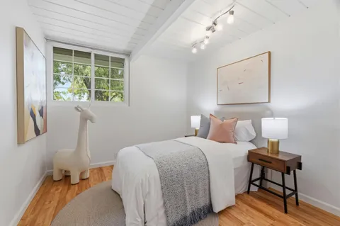 a bed room with a bed and a window