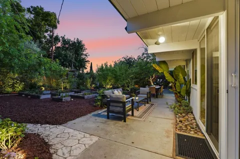 a view of a patio with table and chairs and potted plants