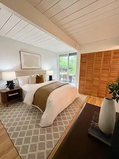 a bedroom with double bed and a window