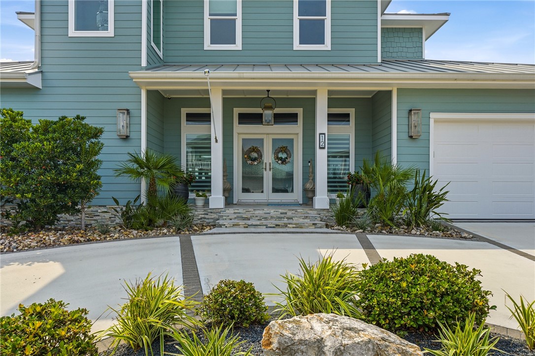 12 Sea Shell Shores Rockport, TX 78382 - Photo 3 of 40 a front view of a house with a yard