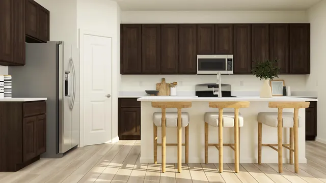 a kitchen with stainless steel appliances stove microwave refrigerator and cabinets