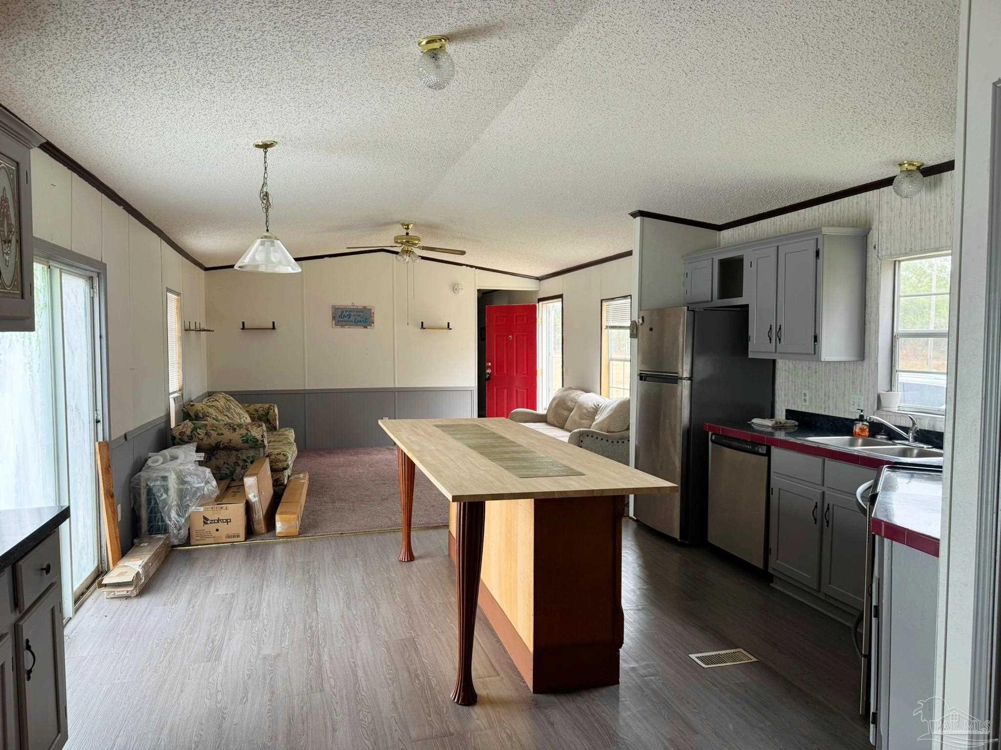 818 Twin Bridges Road Flomaton, AL 36441 - Photo 14 of 33 a kitchen with kitchen island a stove a refrigerator and a dining table with wooden floors