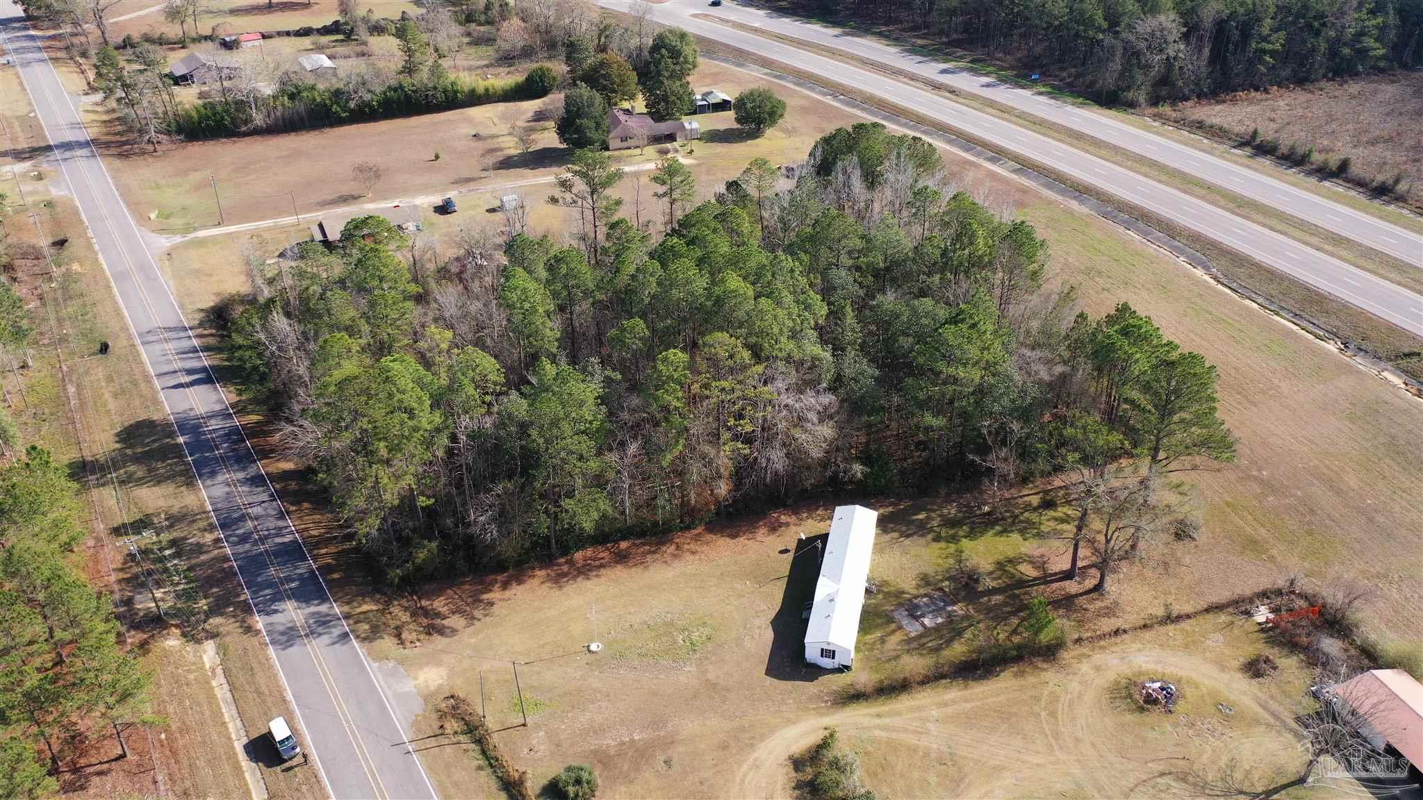 818 Twin Bridges Road Flomaton, AL 36441 - Photo 2 of 33 a view of a yard with potted plants