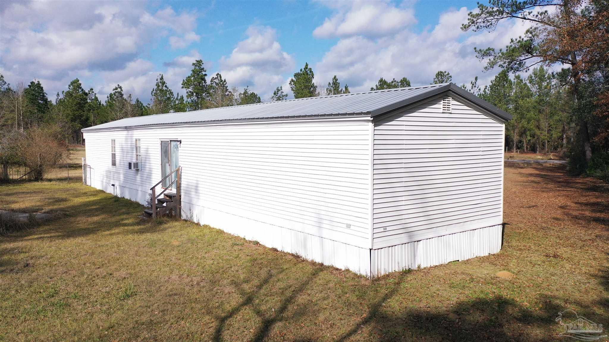 818 Twin Bridges Road Flomaton, AL 36441 - Photo 23 of 33 a view of a white house next to a yard