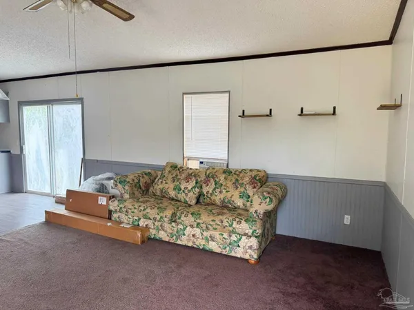 a living room with furniture window and a wooden floor