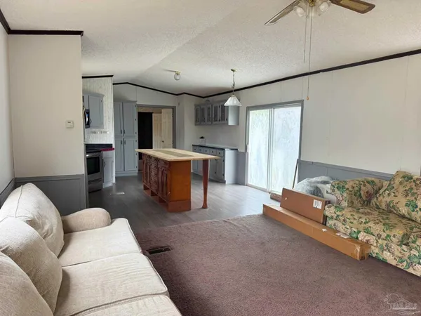 a kitchen with stainless steel appliances granite countertop a refrigerator a stove and a sink