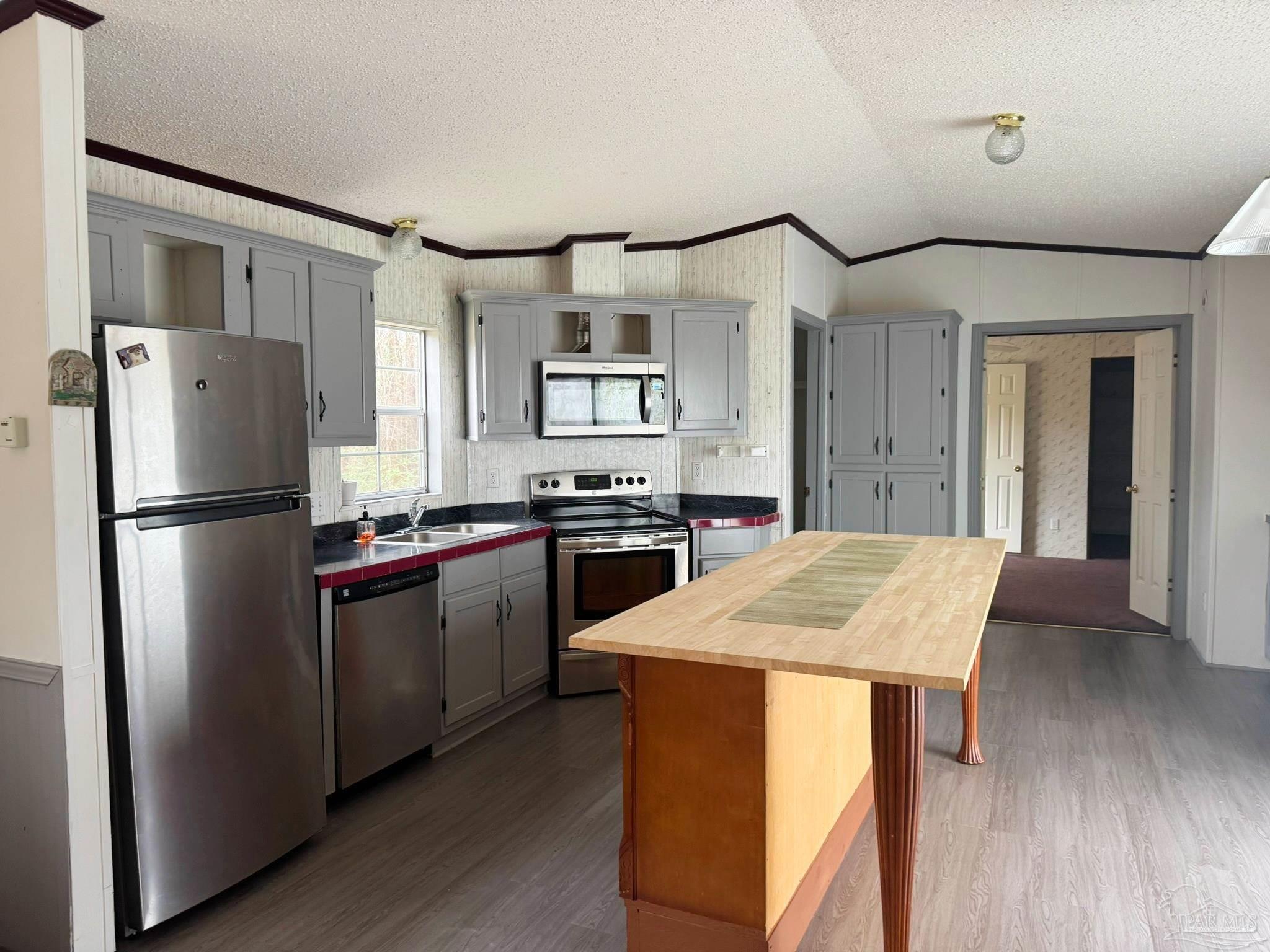818 Twin Bridges Road Flomaton, AL 36441 - Photo 9 of 33 a kitchen with stainless steel appliances granite countertop a refrigerator a stove and a sink