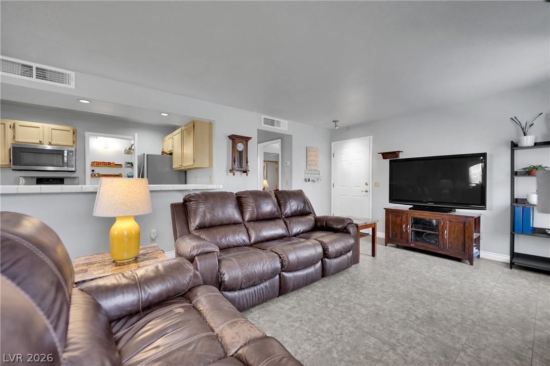 7570 West Flamingo Road, Unit 115 Las Vegas, NV 89147 - Photo 3 of 34 An inviting open-concept living area with seamless transition to the kitchen.
