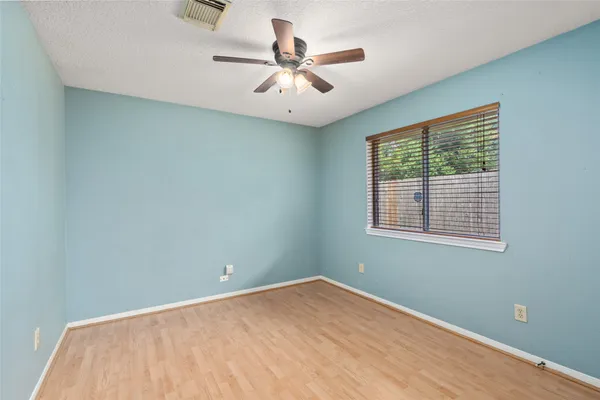 a view of a room with a ceiling fan and a window
